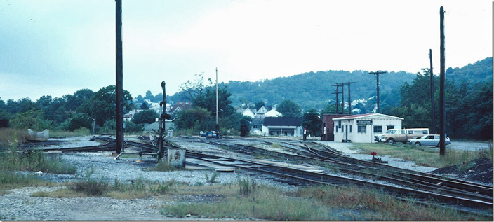 Looking south. The steam engine house would have been out past the new locker room building. The fuel stand appears to be no longer in use. That’s my gray 1977 Toyota Corolla parked on the right. I suppose that is the WV&P SD extending on down the to the river to the left of the pole. B&O Clarksburg.