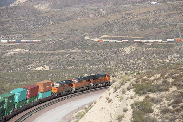 BN-SF 6720, BN-SF 6681, and BN-SF 6926, all GE ES44AC, are seen pulling a unit stack train down the west side of Cajon Pass using Track #2.