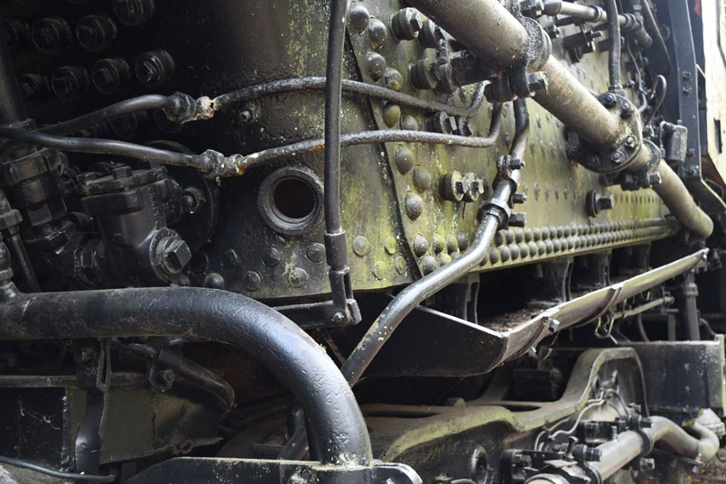 All I can determine about that large hole at the bottom of the mud ring involves draining water during a routine boiler wash. It probably had a plug at one time, but this was unnecessary after the boiler was drained. There are smaller plugs on the boiler to facilitate washing it out each month. Below the boiler and firebox is the ash pan.