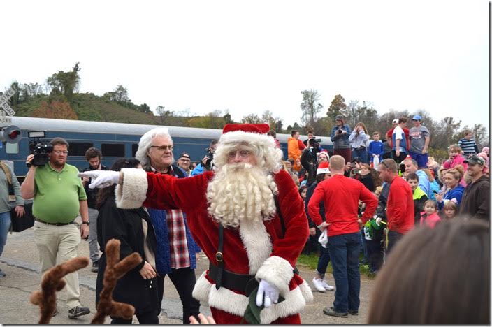 Ricky Scaggs and his wife follow Santa to their excited fans.