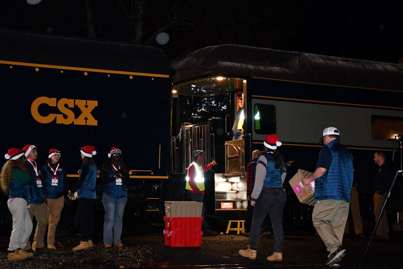 Volunteer Elves mingle near the train.