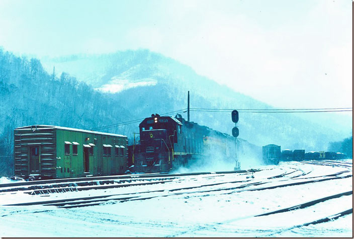 A couple of days later on New Years Eve westbound manifest No. 97 rips through Shelby on the main line. GP38 4827 with 4168-3763 provide plenty of power. Prior to the merger with SBD, C&O manifests terminated at Elkhorn City. The green boxcar was used briefly as a switchman’s shanty. Shelby KY. 12-29-1976.