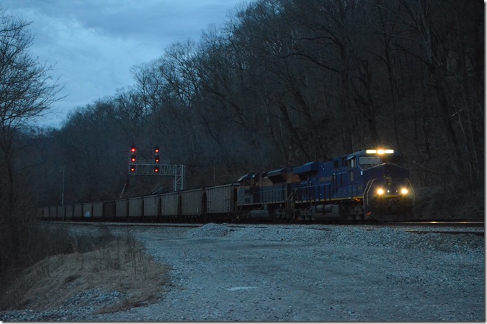I saw the headlight of an eastbound waiting for 17M to clear. Eastbound 756-12 (Williamson – Belews Creek NC power plant) with NS 8103-1071 blasts out of town with 110 loads. NS 1037-7271 were on the rear in DPU mode. This train loaded at the Big Omer mine, fka Marrowbone Development, at Naugatuck. Rawl WV.