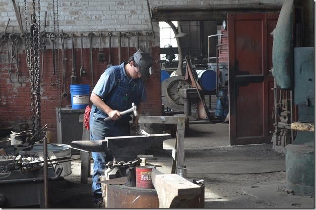 Apprentice blacksmith forging a bull pin used to drive out rivets and bolts.