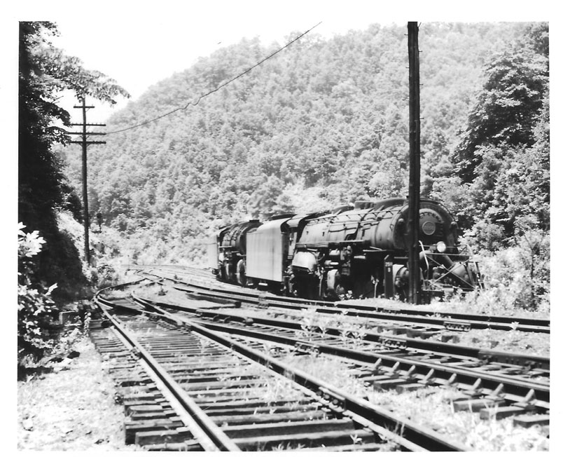 The sidings serve a coal tipple. The pusher will return to Weller. The "big pusher" now consists of three 6-axel AC units.