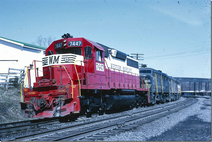 In a little while the hill helpers drop down and stop at the train order office. SD40 7447 and ALCo FA2s 302-301-304 have the duty this day. WM Williamsport MD.