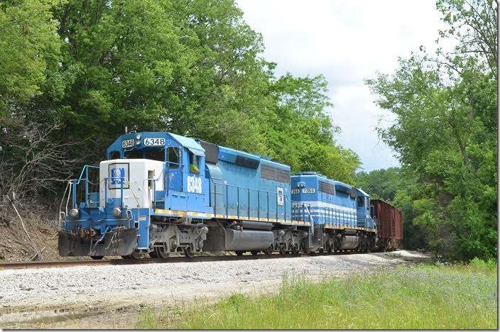This w/b Wheeling empty stone train is stopped for a re-crew at the crossing at Tymochtee, a few miles east of Carey. No. 6348 was an ex-EMDX lease engine. It was previously Soo line and originally Milwaukee Rd. SD40-2s will live forever! The blue is OK, but I can’t wait until they get painted in the Rio Grande-inspired scheme. WLE 6348-7356. Tymochtee OH.