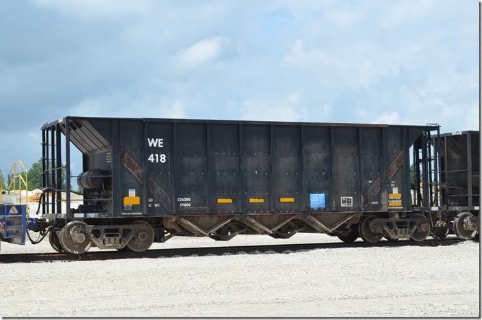 Wheeling & Lake Erie hopper 418 was being loaded at Stone Co. (Shelly Minerals) at Carey OH 06-18-2015. Cars in WE series 400-449 were renumbered from a JAIX 80000 and 90000 series. I know nothing about these cars beyond that; they were rebuilt before 1991. I suspect that they were shortened from older coal-carding cars of 3800 cubic feet capacity (current capacity is 2531 cubic feet). WE 418 is ex-JAIX 80272.
