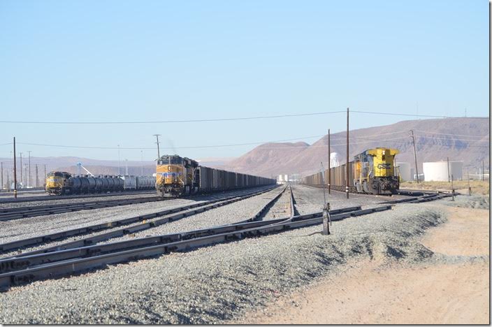 Union Pacific’s crew change point is Yermo, a few miles east of Barstow. Yermo isn’t much more than a wide spot in the road that the I-15 bypassed. Left to right: UP 8493 on e/b frt, DPU 7768 ready to depart on a w/b coal train, CSX DPU 467 on a w/b coal train. Yes, the score at Yermo is coal trains 2, non-coal 1! Yes, this is environmentally crazy California! Yermo CA.