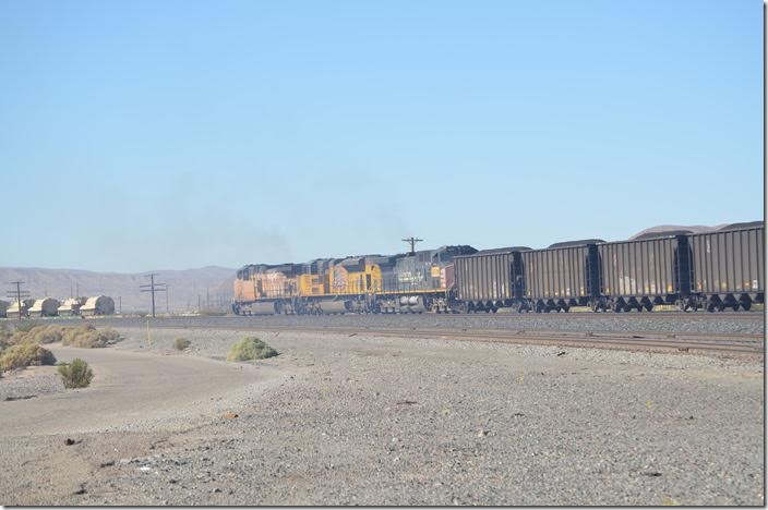 The coal train is not leaving town but pulling forward so the DPU helpers can be fueled. Those armored vehicles hint that the U. S. Marine Corps logistics base is just over there. There are several Marine, Army, USAF, and USN training bases nearby. UP 6511-8713-6318. Yermo CA.