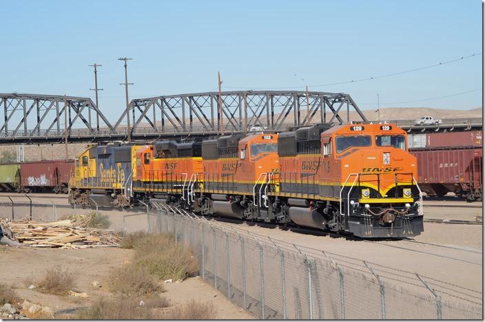 BNSF Geeps 129-102-2516-183 are parked on a lead that appears to have gone to the old roundhouse. Facilities east of the bridge appear to be part of the original yard. Barstow CA.