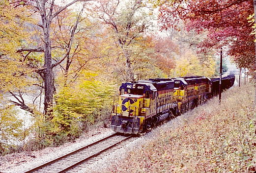 At Camden-On-Gauley we found Chessie System GP40-2s 4147-4327-4136 sitting on the main with a string of empty hoppers.