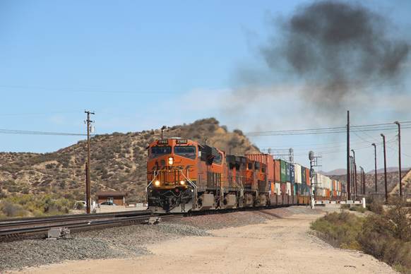 BN-SF 7902, a GE ES44DC; BN-SF 5406, a GE C44-9W; BN-SF 4512, a GE C44-9W; and BN-SF 6631, a GE ES44C4, are passing Summit westbound.