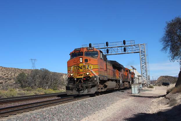 BN-SF 4103, a GE C44-9W; BN-SF 7891, a GE ES44DC; and BN-SF 6834, a GE ES44C4, are seen westbound passing a hotbox detector.
