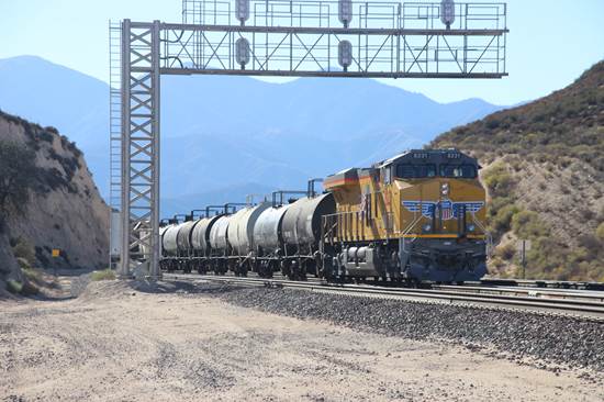 UP 8231, a GM SD90/43AC, is no longer pushing its train of oil tank cars but instead is providing dynamic braking as its 90 car unit tank train descends the west side of Cajon Pass.