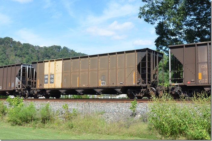 GNFX hopper 91112 (City of Gainesville, FL) has a load limit of 233,700 and a volume of 4000 cubic feet. It was built by Trinity in 09-1992. On westbound empty train leaving Shelby on 09-19-2015. Fords Branch.