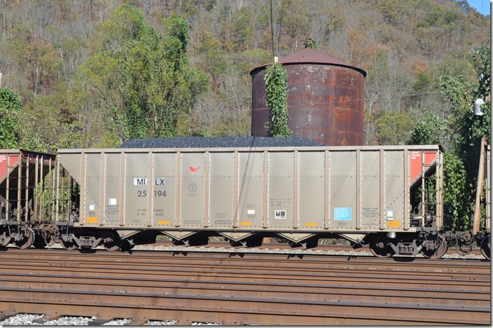 Sister car. That old water tank is the last steam-era servicing structure left at Shelby KY. It is being eaten by kudzu! MILX hopper 25194.