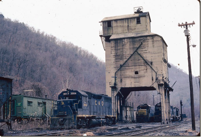 Notice camp car X-1. I think this coal dock is still there. Massey Coal built an enclosed belt line across the highway, river, and yard at this location to feed the Sylvester prep. plant. Big Coal, Cabin Creek SD.