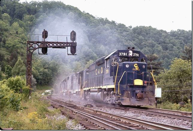 C&O 3791-6060-4826-6138 starting an e/b coal train on main line at Fords Branch. The main track in the foreground becomes the Shelby switching lead east of this crossover. 05-29-1972. Big Sandy SD