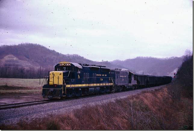 C&O 7304-5777 w/b 143-car coal drag at west end of Pauley passing siding. 12-1970. Big Sandy SD.