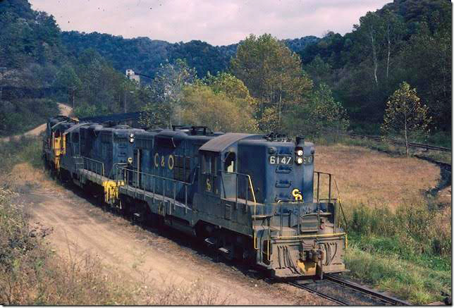 C&O 6147 et al supplying empties at Bethlehem Steel #22 at Deane KY. C&O on hill on left; L&N on right. 10-1977. After the merger the L&N was removed, and now all loading for the Rapid Load tipple is done on this track. E&BV SD Martin.
