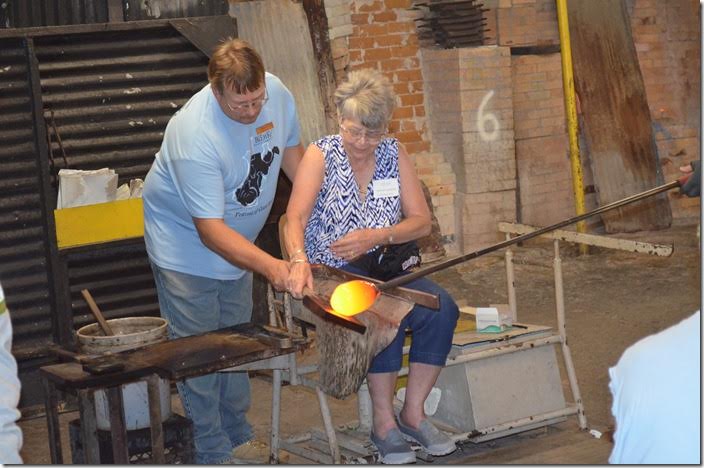 The art of glass blowing and shaping was being demonstrated hands-on to a group of visitors. Blenko Glass.