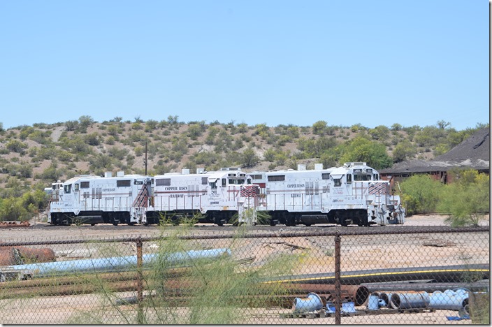 I took these photos from the parking lot behind the plant office. These engines may be stored, because there doesn’t appear any unused tracks at the Hayden Jct. yard. There is a center cab switcher parked or stored in the background. CBRY 203-201-202. Hayden AZ.