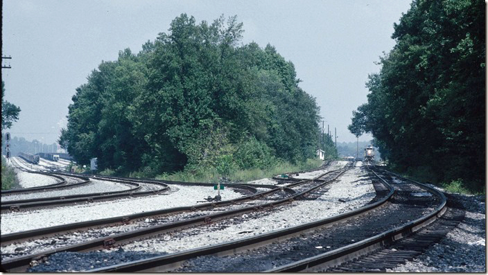 View of the south end of the yard. The main line signal on the far left is “Bacon Creek.” The engine in the distance is working in the east yard. 09-17-1989. CSX Corbin KY.