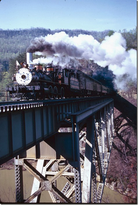 CC&O #1 crossing Pool Point bridge near Elkhorn City with s/b excursion. View 2. 04-27-1975. 