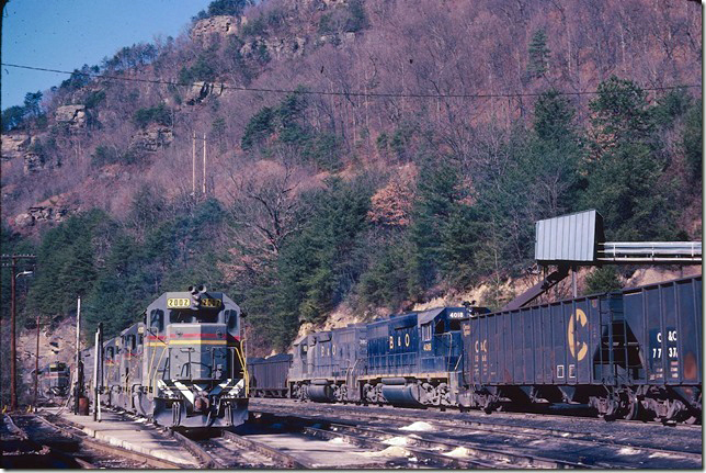 It is 01-18-1981, and that messy fueling track has been upgraded with concrete and collection pans. In fact upgrades were made at Dante, Shelby, Loyall and Hazard at this time. B&O 3825-4018 ease out of the yard with empties for Shelby. CRR 2002-6002-2008 have the new Family Lines paint scheme.