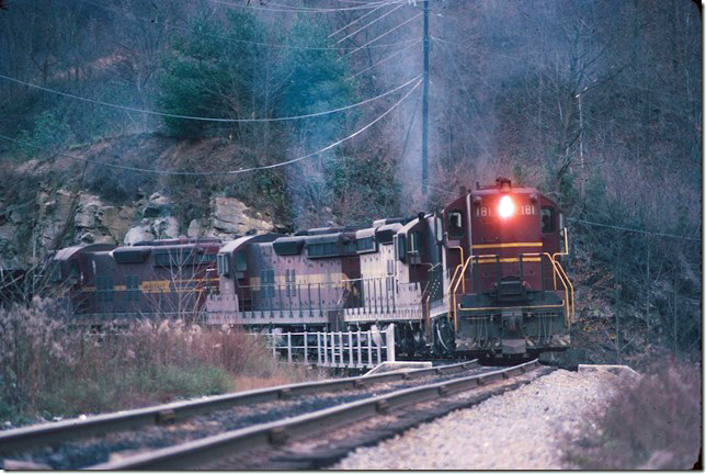 Leased DM&IR SD18s 181-179-190-191 negotiate the curvy Greenbrier Branch (“Haysi Railroad”) near Haysi taking empties to supply Clinchfield Coal’s tipple at Vicey. 11-12-1977.