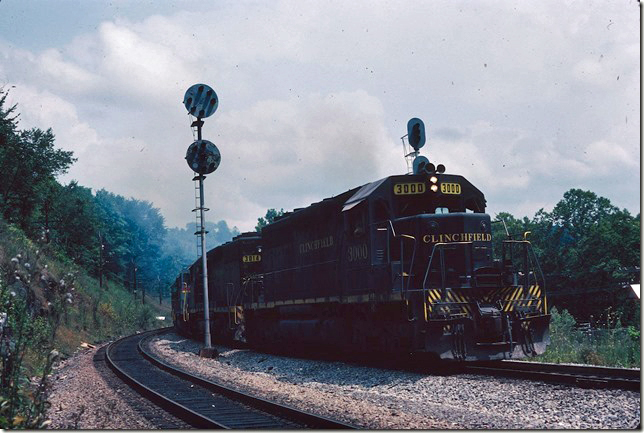 CRR 3000-3014-2000-2009 have 49 loads of coal southbound over the N&W crossing between Boody and St. Paul. 08-25-1979.