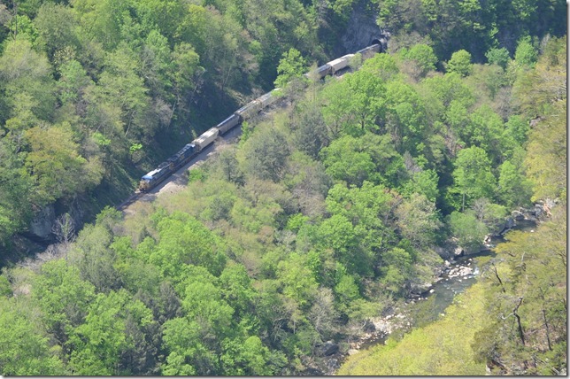 From last Sunday, 4-27-14, at the Breaks Interstate Park. Southbound loaded grain train behind 7657 with 90 cars and a two unit pusher from the State Line Overlook. The train is coming out of State Line Tunnel. 