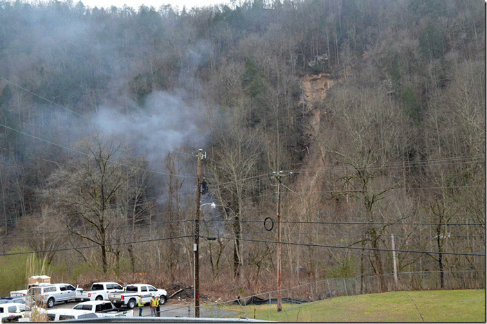 View from US 460 showing small fire still burning on river bank and the extant of the slide.