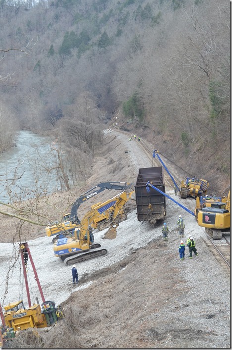 Three excavators move up to keep the hopper from tipping. View 3. CSX derailment. Draffin KY.