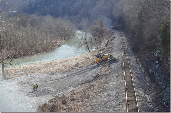 B&P Enterprises, a contractor specializing in railroad work including wreck cleanup, brought in a fleet of dump trucks to haul stone to fill the soft river bottom with a huge pad. 02-15-2020. CSX derailment Draffin KY.