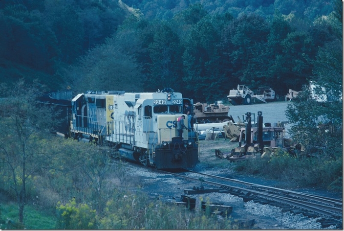 The loading is finished and B880/B881 start down the branch for Westernport past stored dozers and pans used in surface mining. CSX Georges Crk SD.