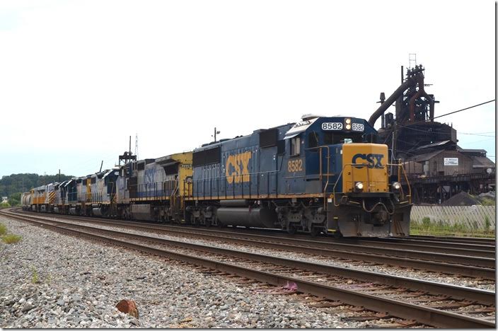 CSX SD50 8582-7778-2508-2317-6158-CREX 1518-1522 with 78 cars of eastbound Q302 roll past AK Steel’s idle Amanda blast furnace. CSX lost ore, coke, limestone and slab business; Kentucky Power lost huge revenue. Hopefully it will resume operation, but there are no guarantees. Bellefonte.
