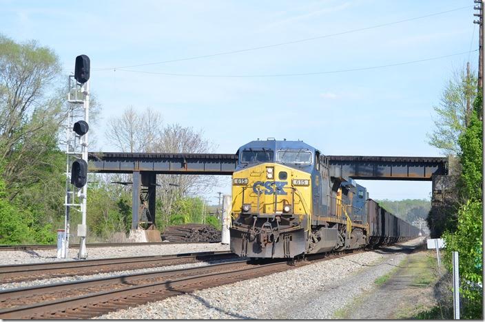 CSX 615-7925 hustles w/b through Kenova under NS at the site of the old union station. 04-18-2015.