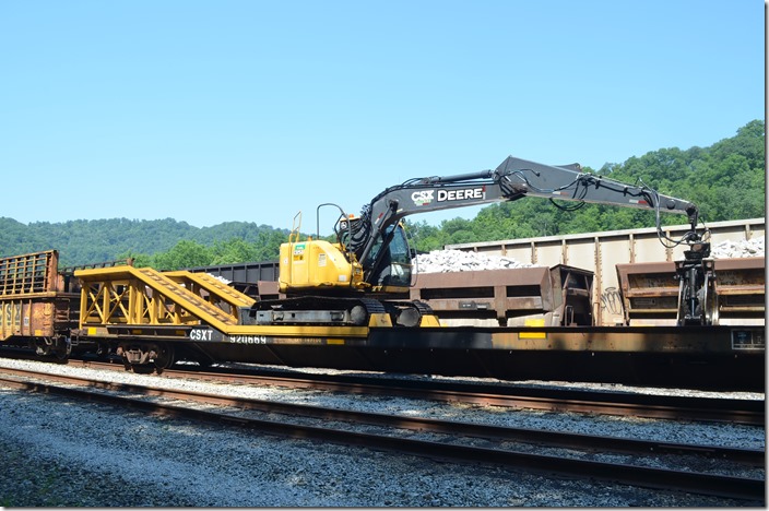 The John Deere crawls from car to car and drops off ties. CSX MW 920669. Shelby KY.
