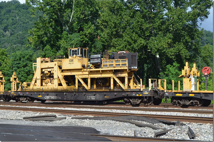 CSX MW flat 988886 appears to support equipment that pulls the ribbon rail for placement. Shelby KY.