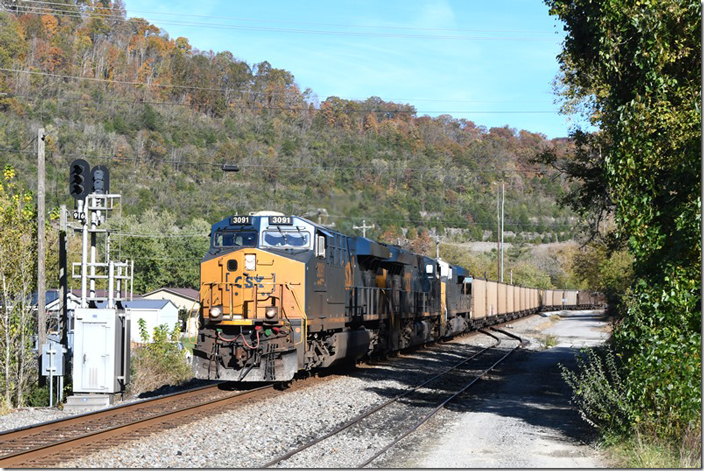 CSX 3091-3422-3116 on w/b E402-23 (Shelby-Russell mtys) which on this day were 97 DKPX (Duke Energy). Betsy Layne KY on 10-25-2023. The siding in the foreground served the old Dunes coal tipple which CSX has wisely left in to park work equipment.