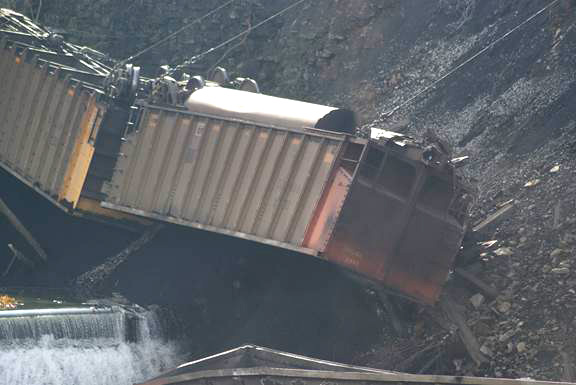 Closeup of one of the derailed cars over the embankment.