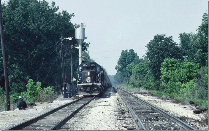 IC 6034-6137 wait on North Siding with a s/b Bluford District grain train. The sand and fuel facility are still in use. IC Fulton KY.