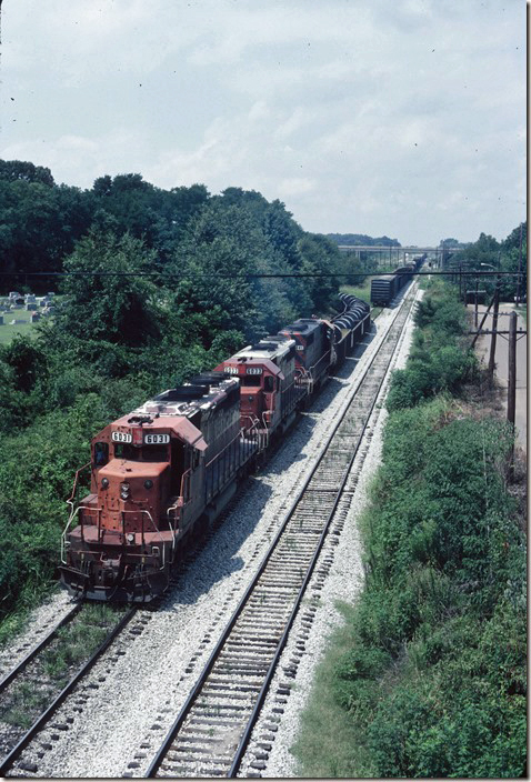 From the US 45 bridge, SE-1 backs around the connecting track to set off or pick up out of the yard. ICG 6031. Fulton KY.