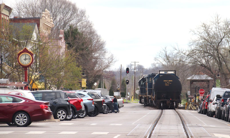 CSXT 6033, CSXT 1132, and CSXT 6582 with UTLX 601645 depart LaGrange. Notice signal Red over Yellow. Train watching viewing tower on the right. The clock did not have the correct time; it was some three hours slow.