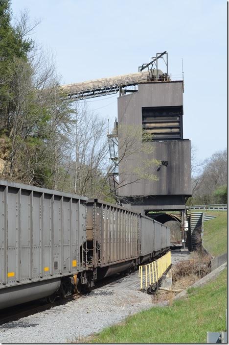 Bell County Coal has NS empty tubs. KY 74 crosses the track ahead of the batch-loader. Bell County uses their ex-C&O GP9 to load the cars. Bell County Coal Hignite tipple Middlesboro KY.