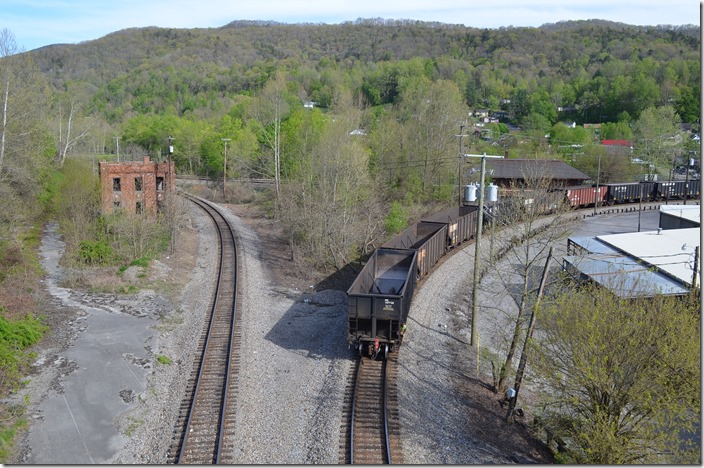 NS mine run U55 shoves 15 empties through Appalachia VA, on April 27th toward Andover Yard. On the left is the new connection to the former Southern (nee-Interstate Ry.). On the background left is the former L&N freight station, and in the right background is the former L&N passenger station. Construction of the highway bridge I’m standing on forced NS to relocate. NS U48 backing. Appalachia VA. 04-28-2015.