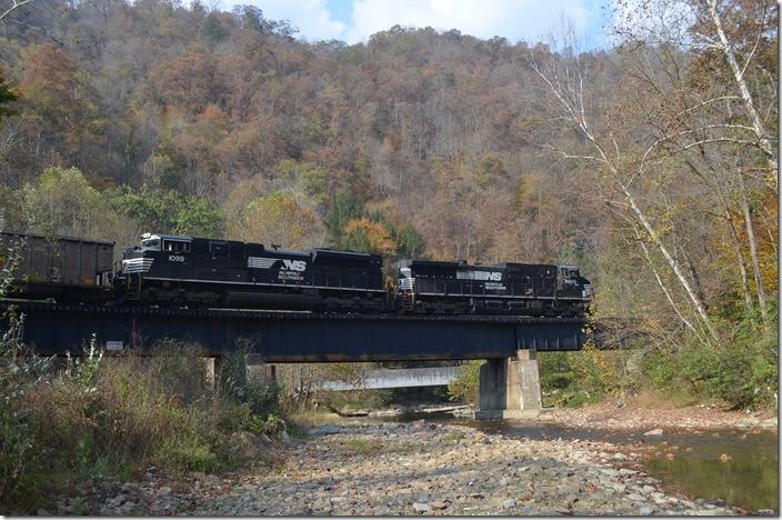 NS 9200-1099 cross Knox Creek near Stopover KY with w/b J42-28 off the Buchanan Branch. This train had 107 loads (Consol Mine at Page VA to Burns Harbor IN) of met coal for Arcelor-Mittal. The crew took it from Weller Yard to Williamson. NS 9200-1099. Stopover KY.