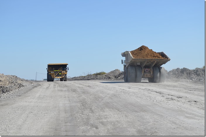 The topsoil carried by the truck on the left will be used for reclamation. 